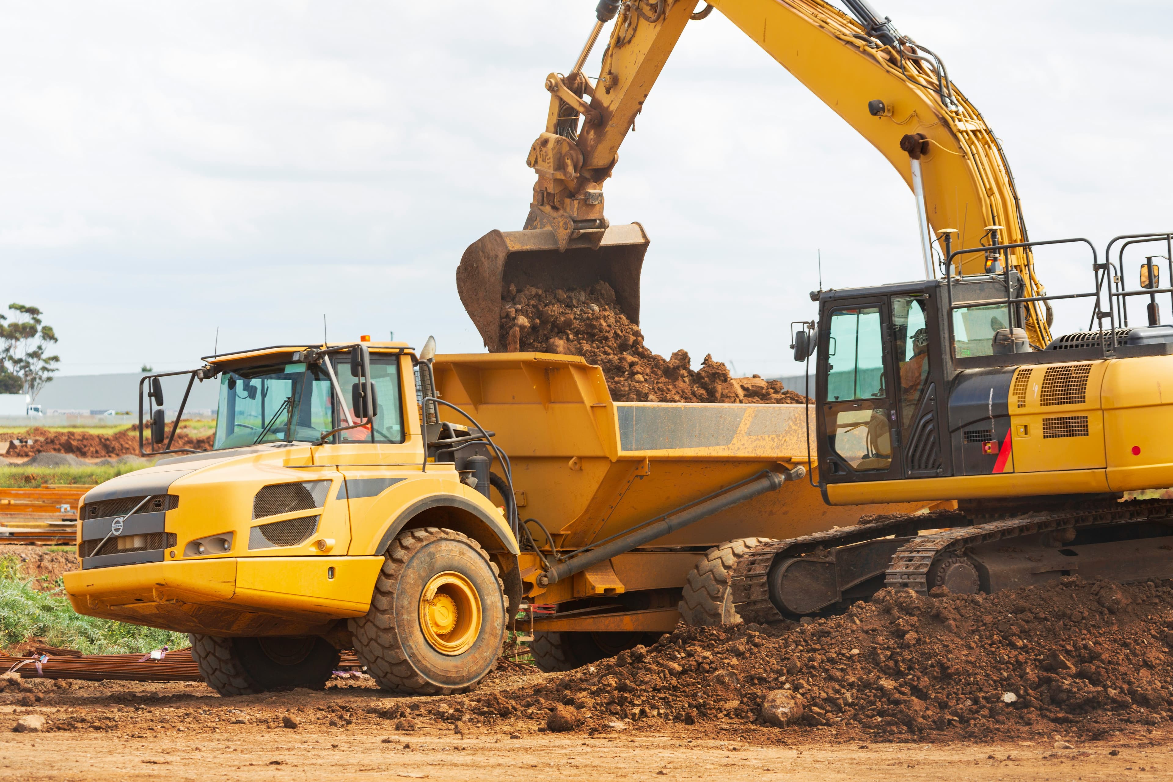 Excavator and haul truck on a practical training site